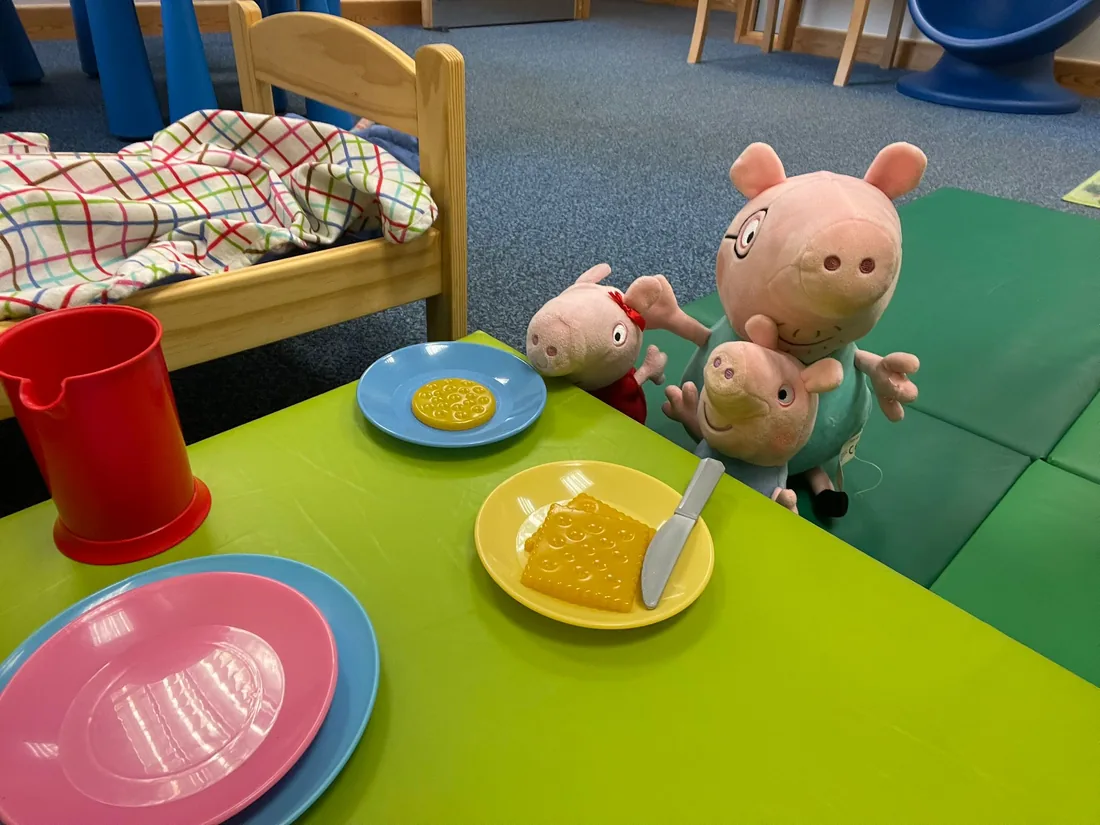 Play table set for a pretend tea party with soft toys in the Speech Stuff therapy room