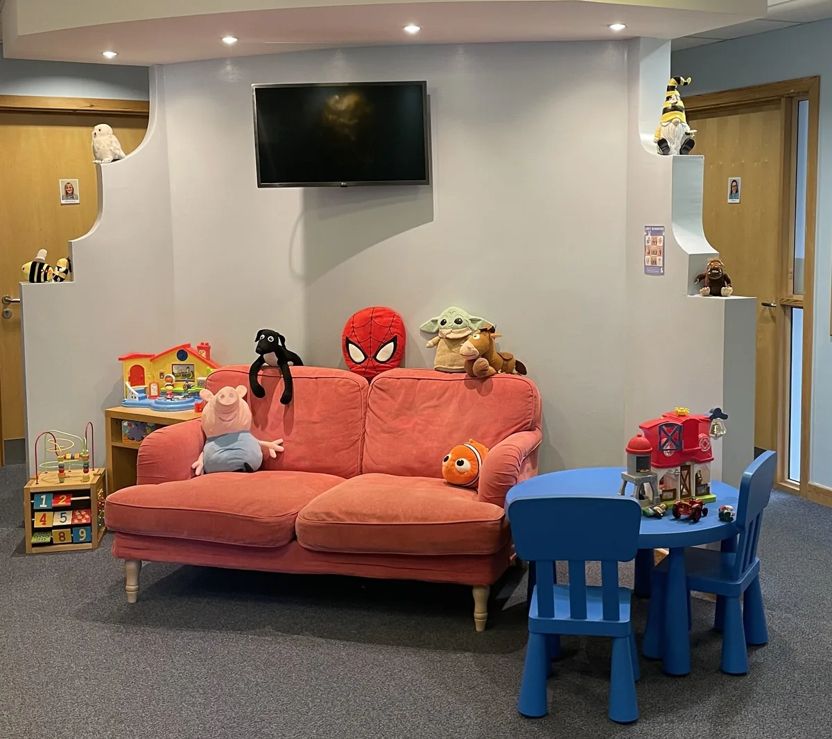 The Hive reception and waiting area - a sofa, toys and a child-sized table